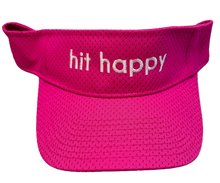 Load image into Gallery viewer, A bright pink mesh visor hat with the phrase 'hit happy' embroidered in white across the front band, shown against a plain white background.