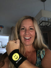 Load image into Gallery viewer, A woman wearing a black Hit Happy Tennis Wristband