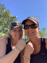 Load image into Gallery viewer, Two women wearing the Tennis Karma Bracelet on the tennis court