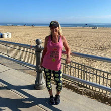 Load image into Gallery viewer, Woman wearing the Hit Happy Tennis Capri Leggings and tank top at the beach