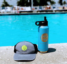 Load image into Gallery viewer, Hit Happy Tennis Water Bottle in Light Blue next to a Hit Happy Tennis Baseball hat and a pool
