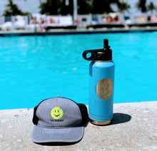Load image into Gallery viewer, Hit Happy Tennis Water Bottle in Light Blue next to a Hit Happy Tennis Baseball hat and a pool