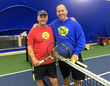 Load image into Gallery viewer, A man wearing the red Hit Happy Tennis- Men's Next Level Triblend T-Shirt on the tennis court