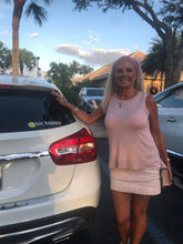 Load image into Gallery viewer, A woman showing off her Black Hit Happy Tennis Car Magnet on her car
