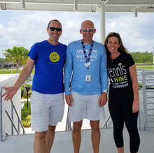 Load image into Gallery viewer, A man wearing the Hit Happy Tennis- Men's Next Level Triblend T-Shirt with friends