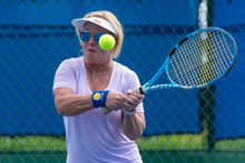 Load image into Gallery viewer, Woman wearing Hit Happy Tennis Wristbands while playing tennis