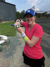 Load image into Gallery viewer, A young girl with our funny Tennis Butt Decals - "Kitties or Puppies" on the end of her tennis racquet