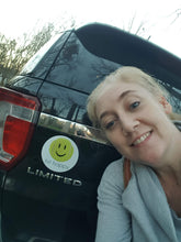 Load image into Gallery viewer, A woman showing off her new Hit Happy Tennis Car Magnet on a car
