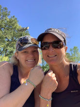 Load image into Gallery viewer, Two women wearing the Tennis Karma Bracelet on the tennis court
