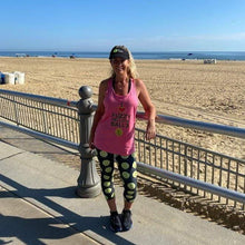Load image into Gallery viewer, Woman wearing the Hit Happy Tennis Capri Leggings and tank top at the beach
