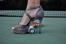 Load image into Gallery viewer, Our funny Tennis Butt Decals - &quot;Flip Flops or Heels&quot; on the end of a tennis racquet with a woman wearing heels

