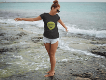 Load image into Gallery viewer, Woman wearing the Black Hit Happy Tennis Women&#39;s Triblend T-Shirt on the beach
