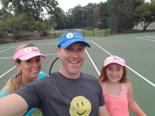 Load image into Gallery viewer, A family wearing Hit Happy Mesh Tennis Visors on the tennis court
