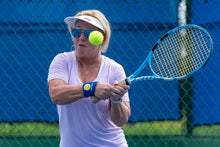 Load image into Gallery viewer, Woman wearing Hit Happy Tennis Wristbands while playing tennis
